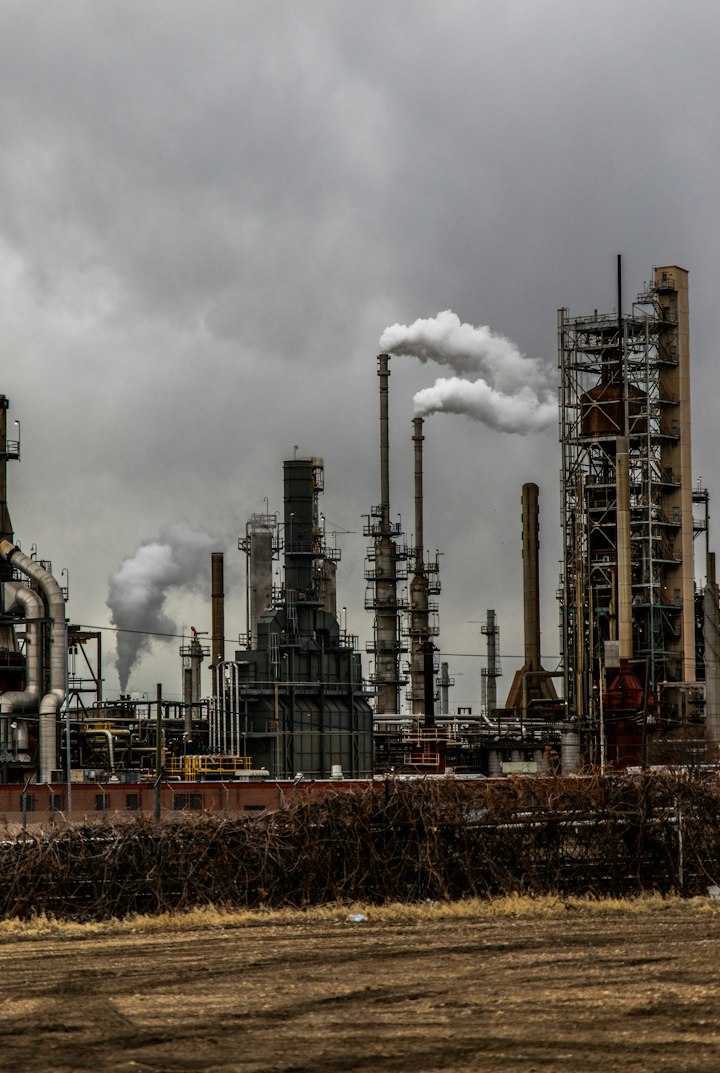 Industrial process plant with stacks and piping at dusk